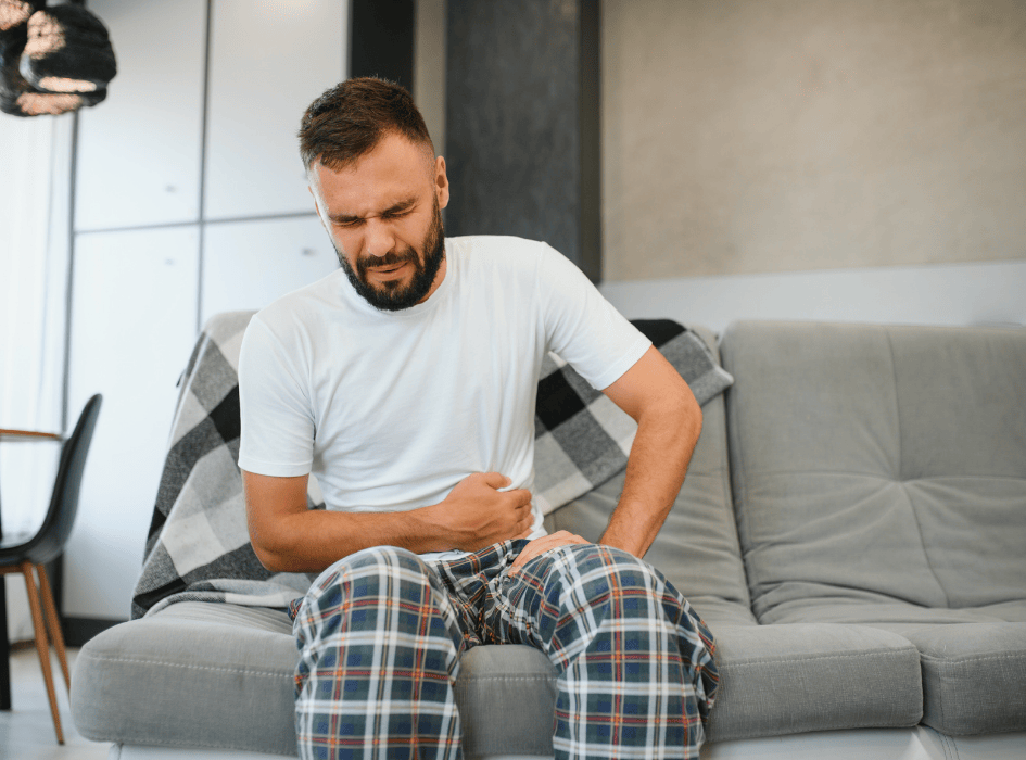 muže bolí břicho, sedí a drží si břicho-cz-alt